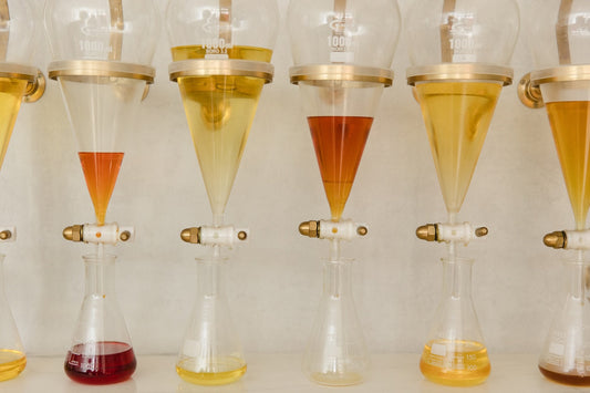 A perfumer weighing materials by hand in the Experimental Perfume Club lab