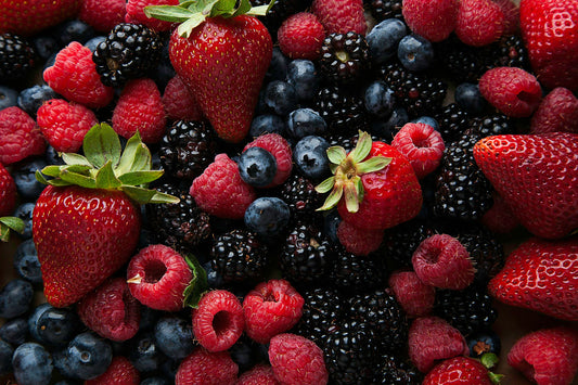 Strawberries and blueberries on a white ceramic plate